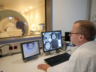 Doctor looks at MRI images on the screen.