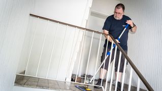 Jochen Dreesbeimdieke reinigt ein Treppenhaus.