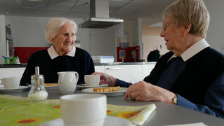 Two deaconesses chat over coffee