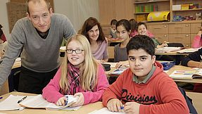 Teachers with pupils in class.