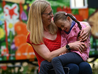 Mother with daughter on her lap