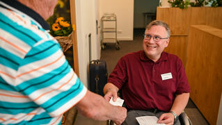 Daniel Ibs serves a guest at reception.