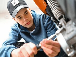 Boy working on moped.