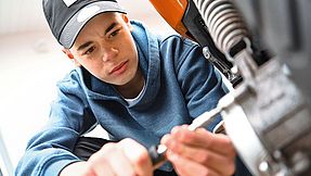 Boy working on moped.