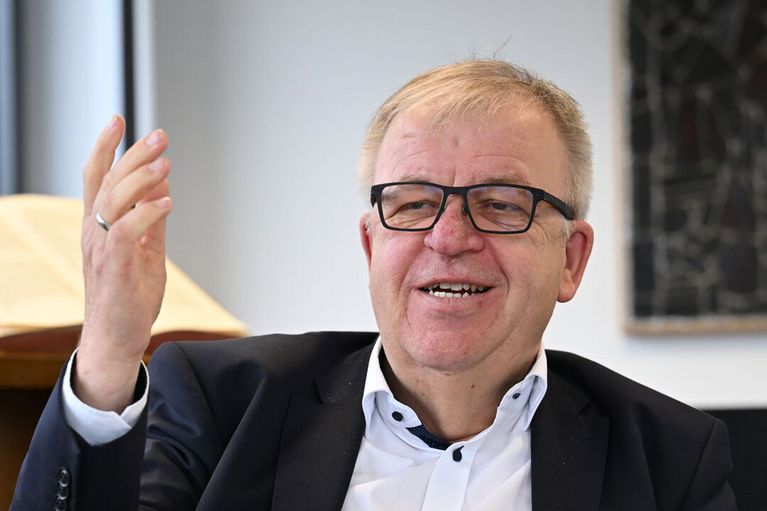 Pastor Pohl sitzt in seinem Büro und gestikuliert.