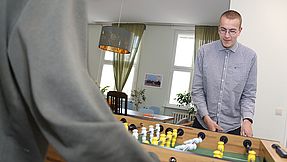 Young people play table football