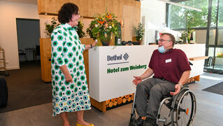 Daniel Ibs talks to a colleague at reception.