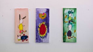 Three of Susanne Hadamitzky's paintings hang on the wall in the studio.