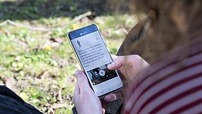 Woman uses the app on her smartphone