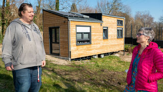 Mike Ertel and Barbara Kristen stand in front of the Tiny House