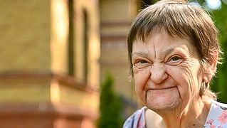 Frau aus Hospiz mit Blumen