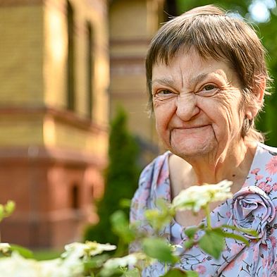 Frau aus Hospiz mit Blumen