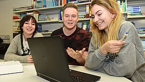 Study group sits in front of a laptop