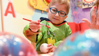 Lenny paints his Christmas bauble